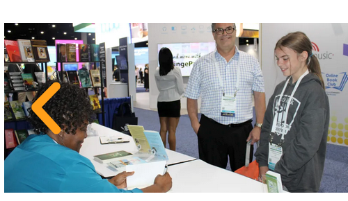 Author signing books with readers